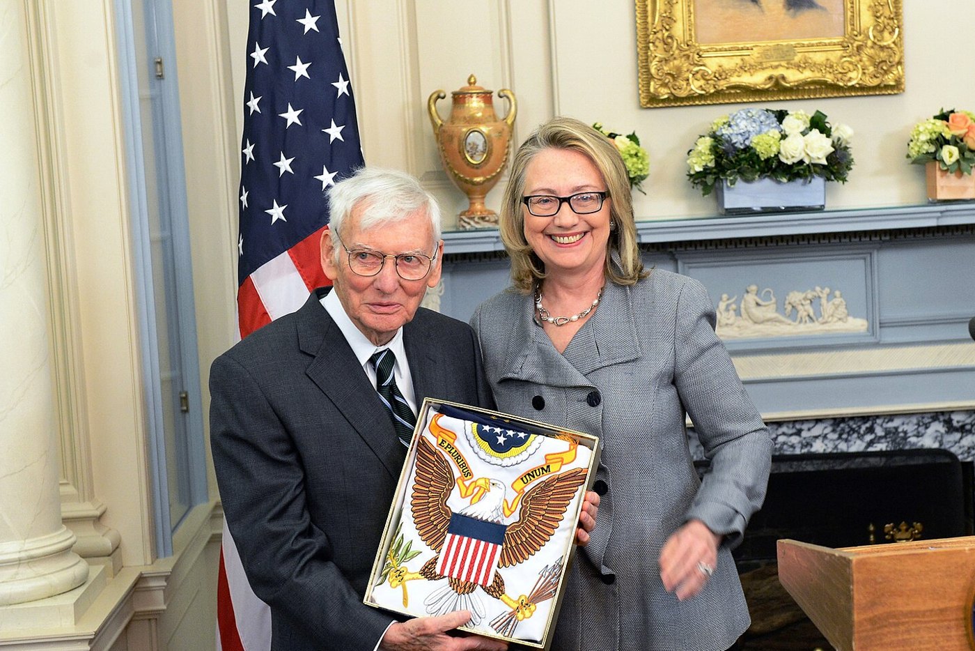 Secretary of State Hillary Clinton honours Ambassador Dan Rooney at a flag ceremony in Washington, January 2013