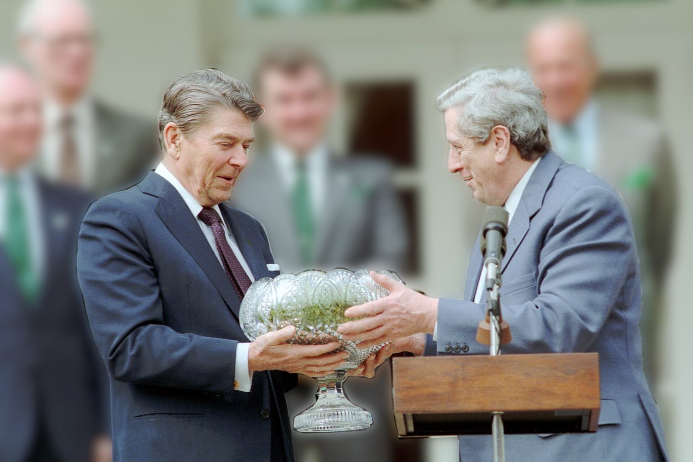 President Reagan receives the St. Patrick's Day shamrock from Taoiseach Garret FitzGerald in the White House Rose Garden, 1986